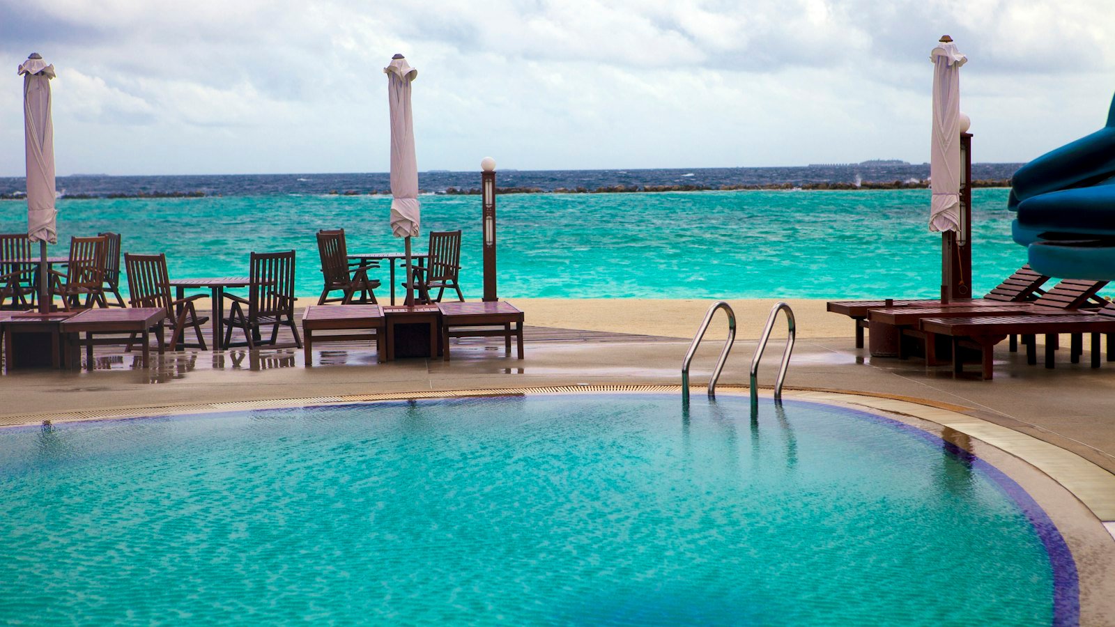 Maldives resort pool beside a turquoise ocean