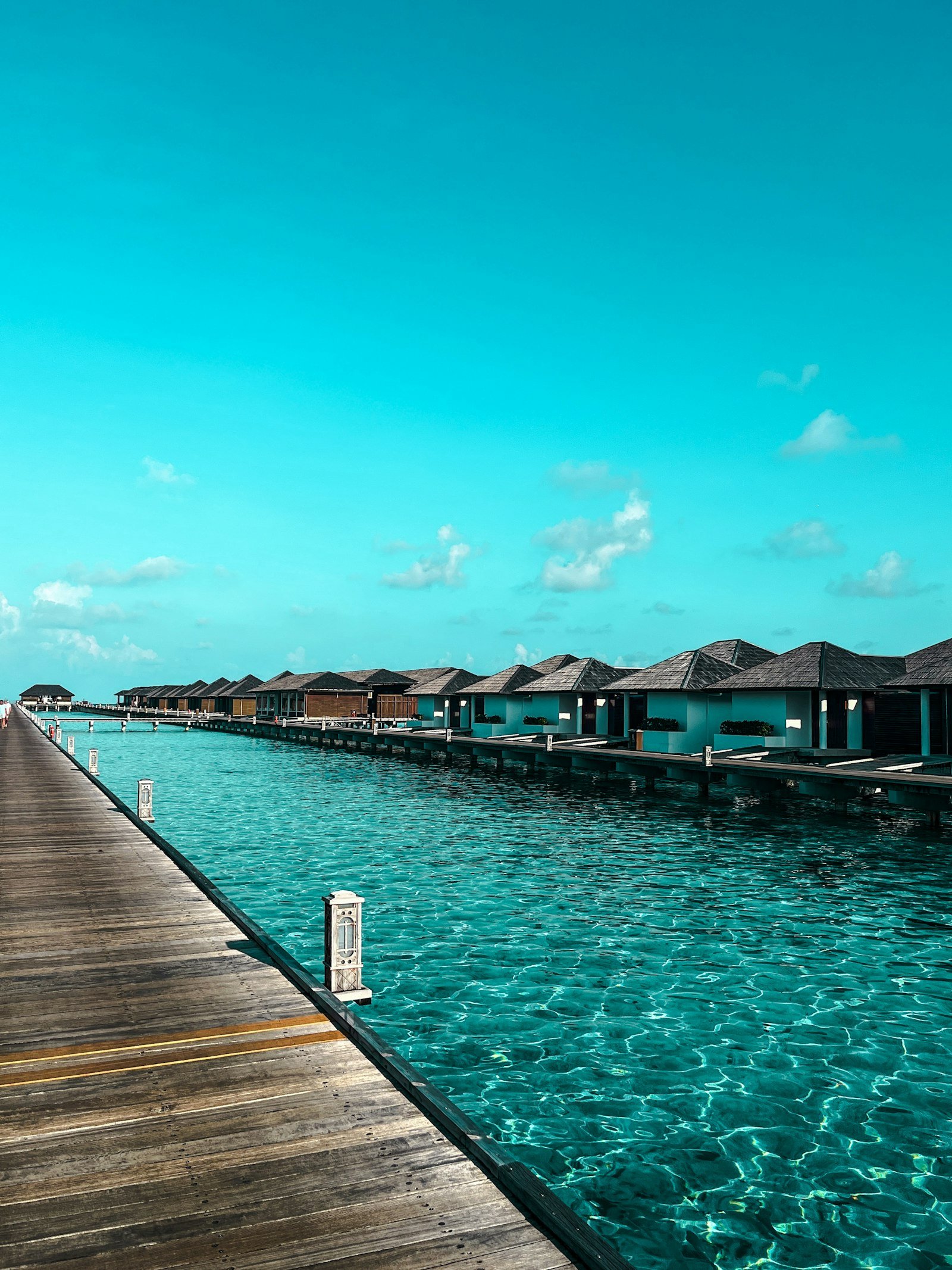 Luxury overwater bungalows above clear turquoise water in the Maldives