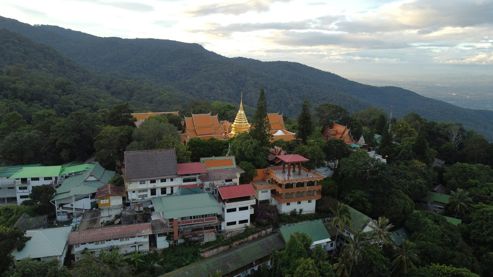 Aerial view of Doi Suthep temple and forested mountains in Chiang Mai, Thailand