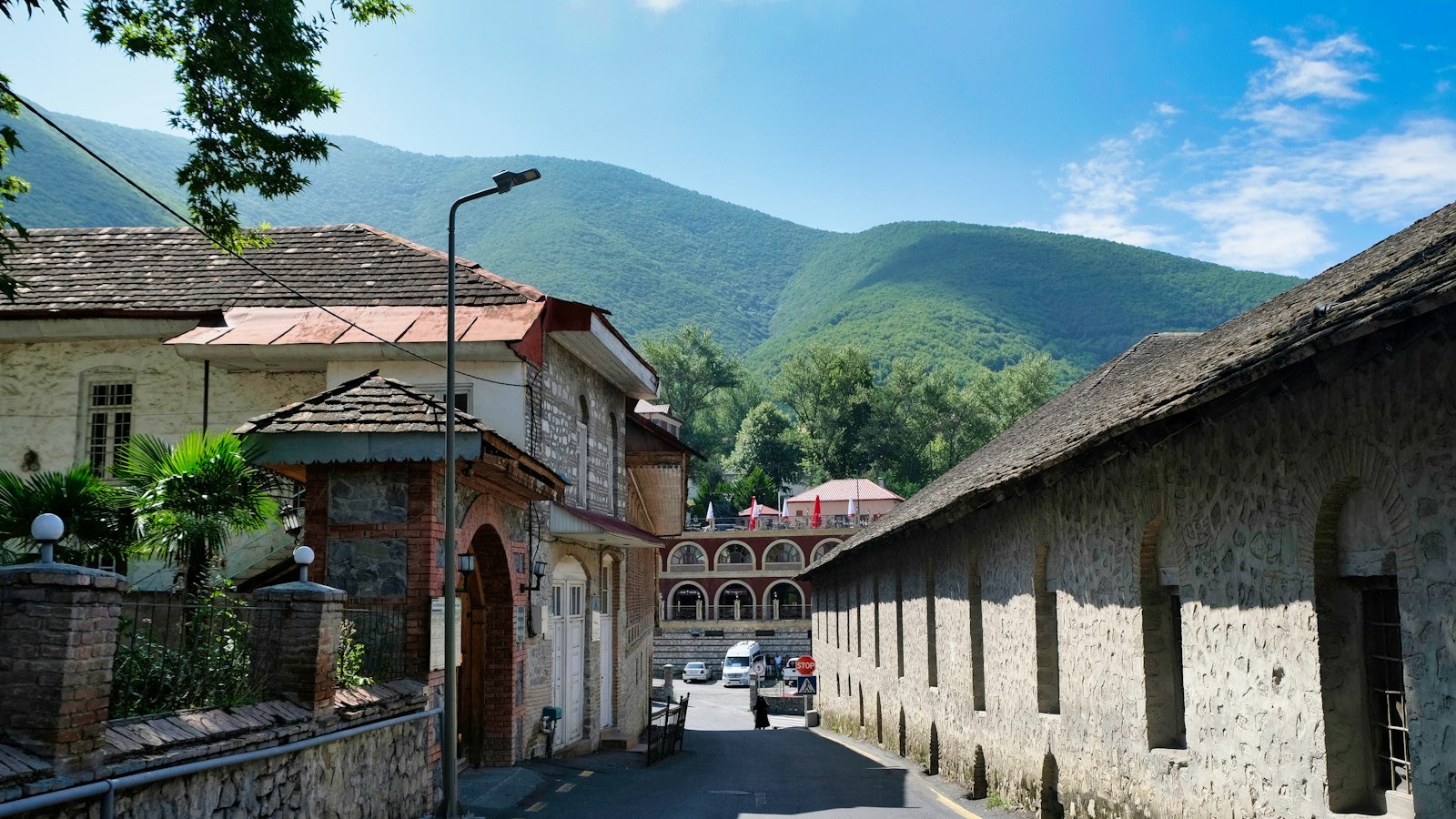 Stone-lined street with Caucasus mountains in Sheki, Azerbaijan