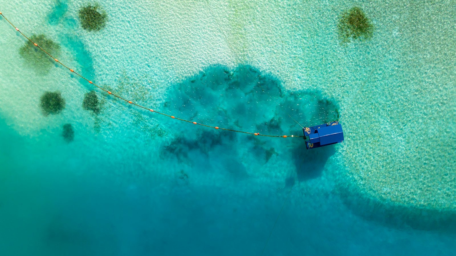 Turquoise shallows and floating structure in Kaafu Atoll, Maldives
